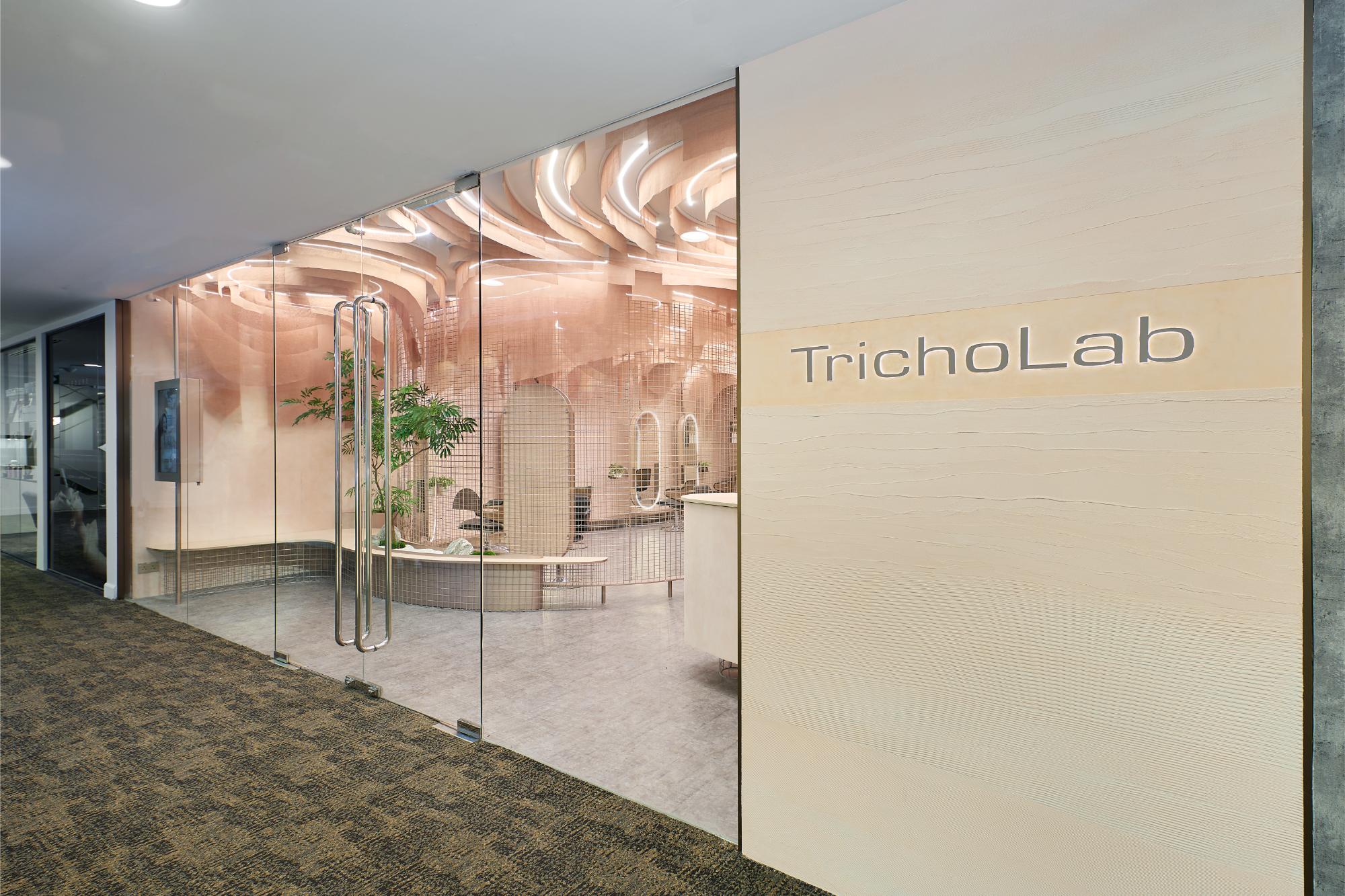 TrichoLab boutique exterior with glass frontage and illuminated TrichoLab signage
