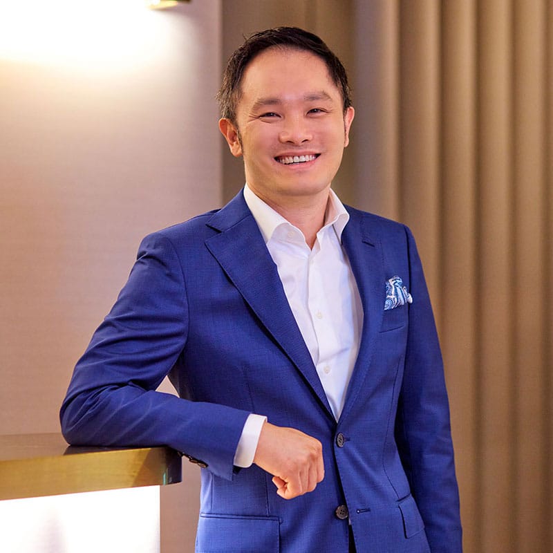 Portrait of Dr Kelvin Chua, founder of TrichoLab, in a blue suit